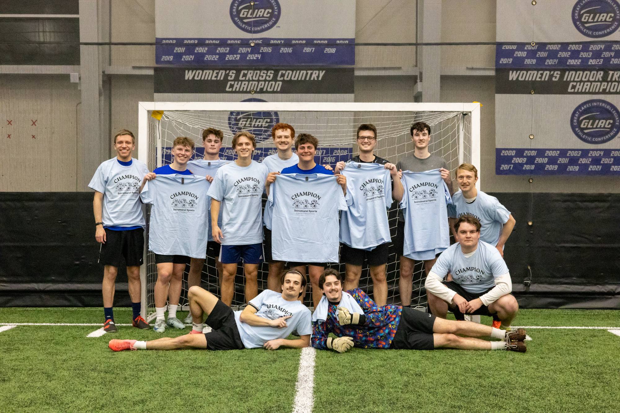 Grand valley students posing with championship t-shirt for winning the soccer bracket.